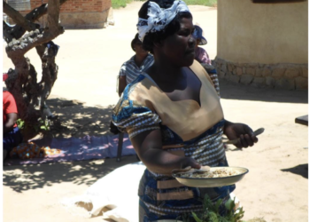 One of the group members of Vusanani Bush mill Feed at Umzingwane District, Matabeleland South, showcasing their indigenous local stock feed produced by a women’s cooperative in their area, also who uses the Biztrack application for their business: Photo: Lungelo Ndhlovu